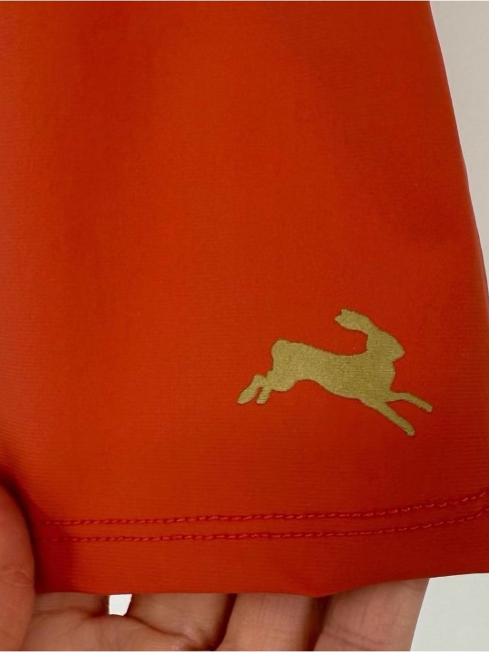 Tracksmith Orange Athletic Shorts with Gold Hare Logo